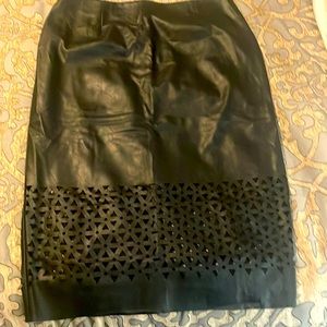 Black some what like used leather skirt a photo of the tag was taken.  No holes